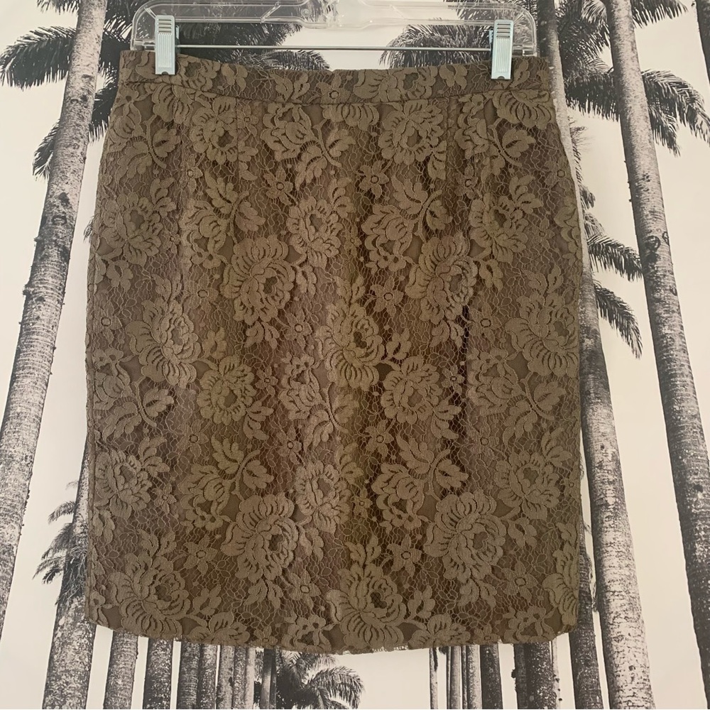 Olive green lace overlay mini skirt with side zipper and lining.